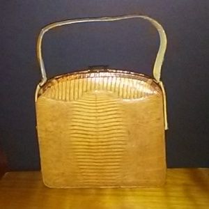 A vintage alligator skin purse handbag.